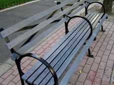 Wooden bench on sidewalk